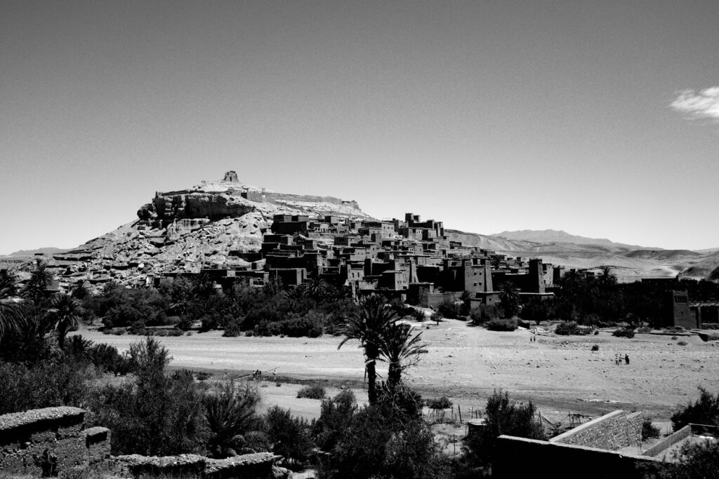 An ancient kasbah village on a rocky hillside in Morocco, warm afternoon light