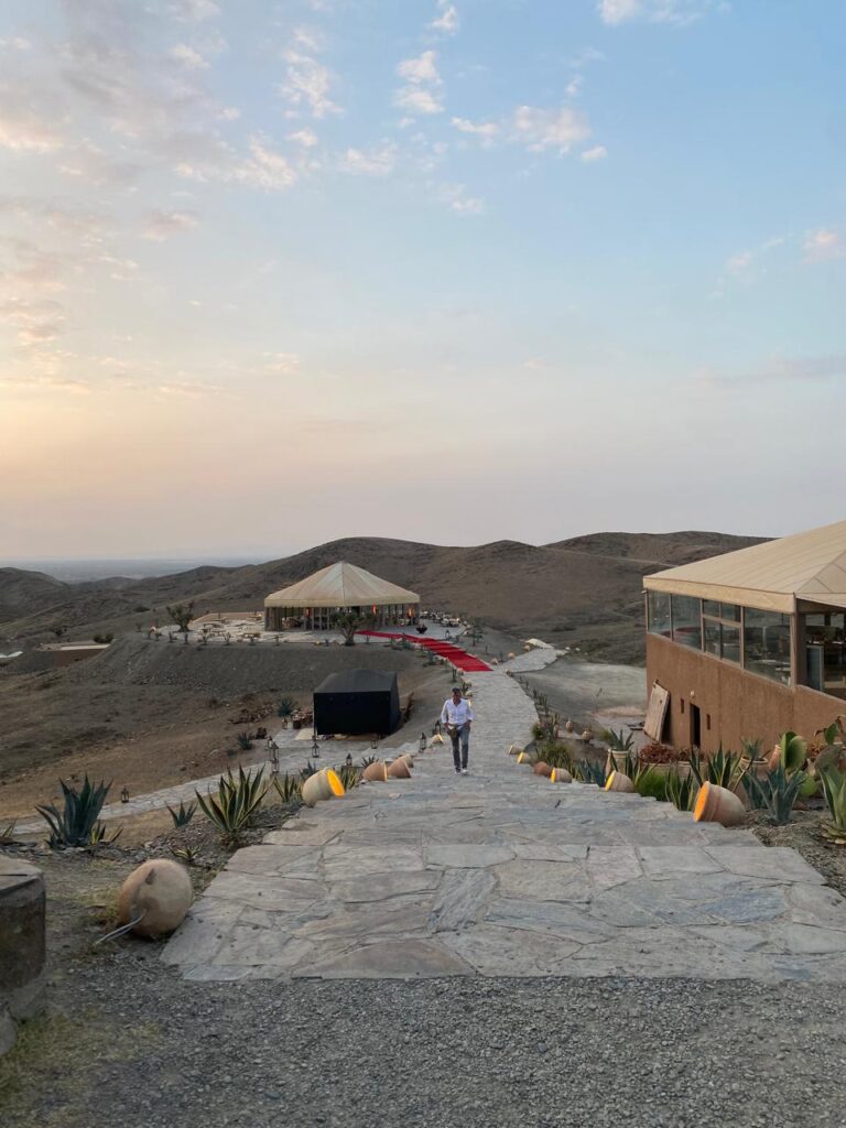 Sunset over the Agafay stone desert near Marrakech, seen from a camp terrace