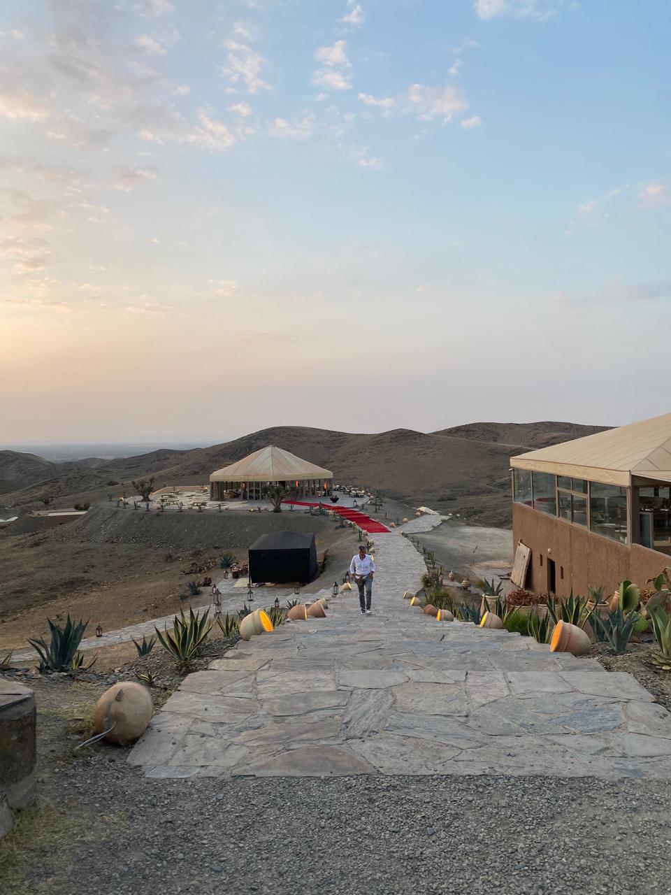 Sunset over the Agafay stone desert near Marrakech, seen from a camp terrace