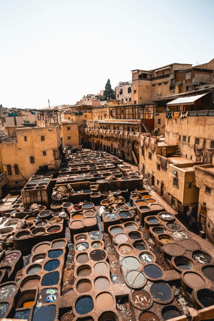 Leather dyeing pits at a traditional tannery in Fes, Morocco, a highlight of a Fes to Marrakech itinerary